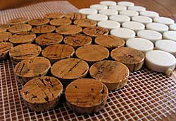 prototype cork tile discs beside production ceramic tile discs